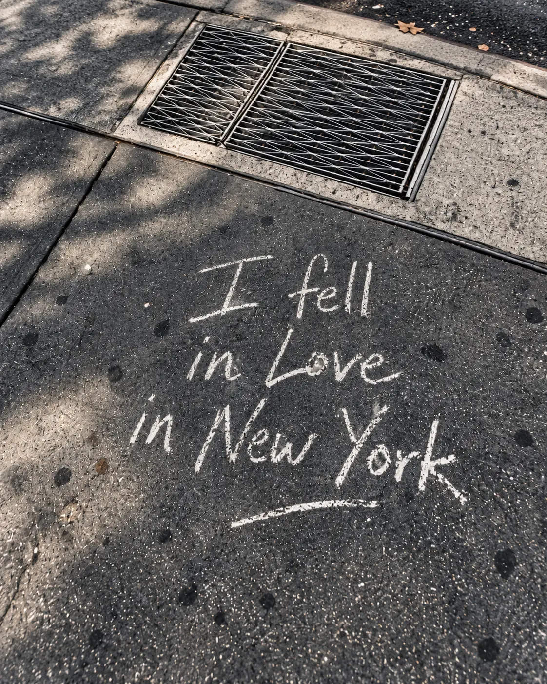 Chalk message reading I fell in love in New York on a city sidewalk